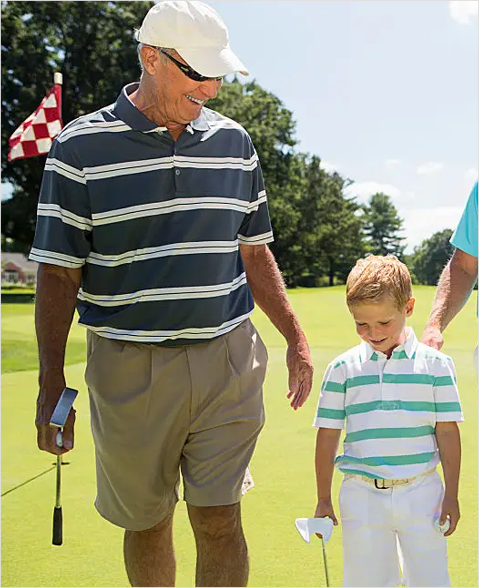 Older gentleman and young man playing golf